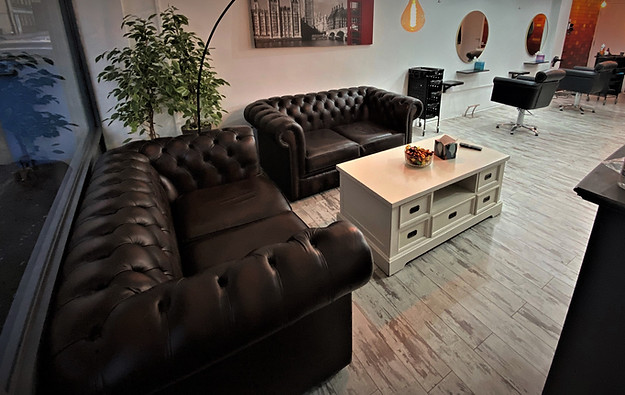 SEoneHAIR salon waiting area with comfortable leather sofas
